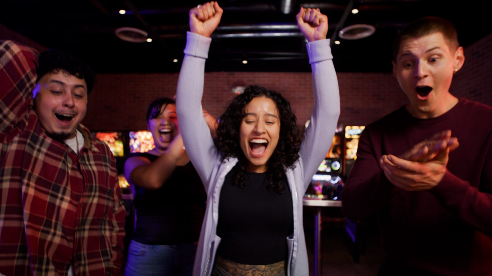 Players celebrating a high score in the pinball room at AYCE Gogi.